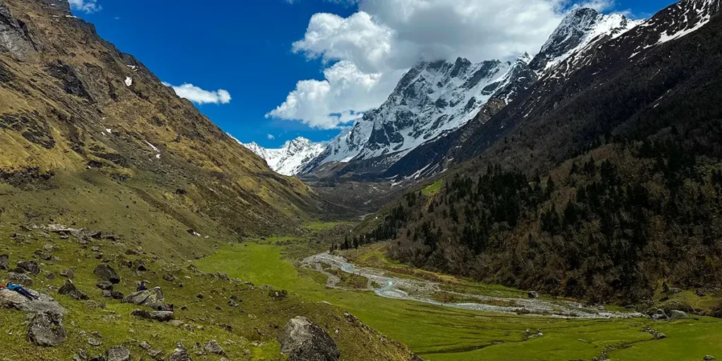 Scenic view of Har Ki Dun valley with lush green meadows and snow-capped Himalayan peaks in Uttarakhand