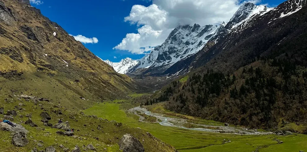 Scenic view of Har Ki Dun valley with lush green meadows and snow-capped Himalayan peaks in Uttarakhand