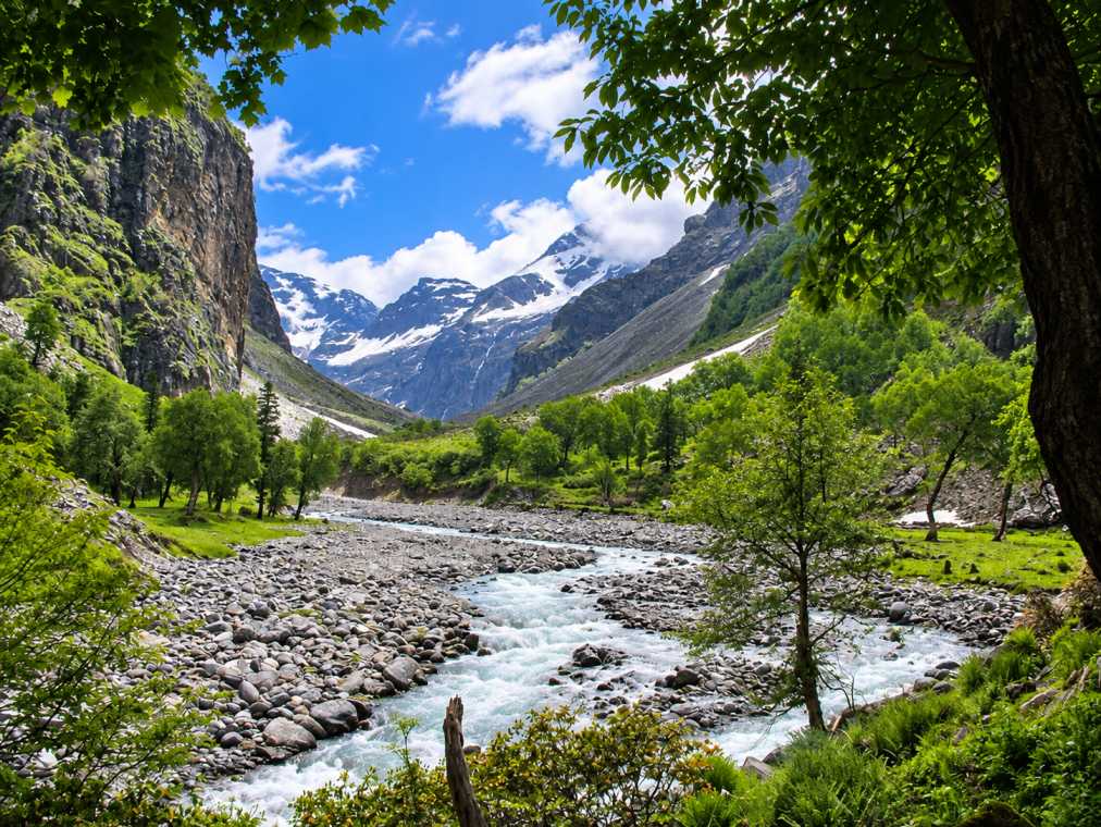 Clear Supin River flowing through the mountain valley along the Har Ki Dun trek in Uttarakhand.