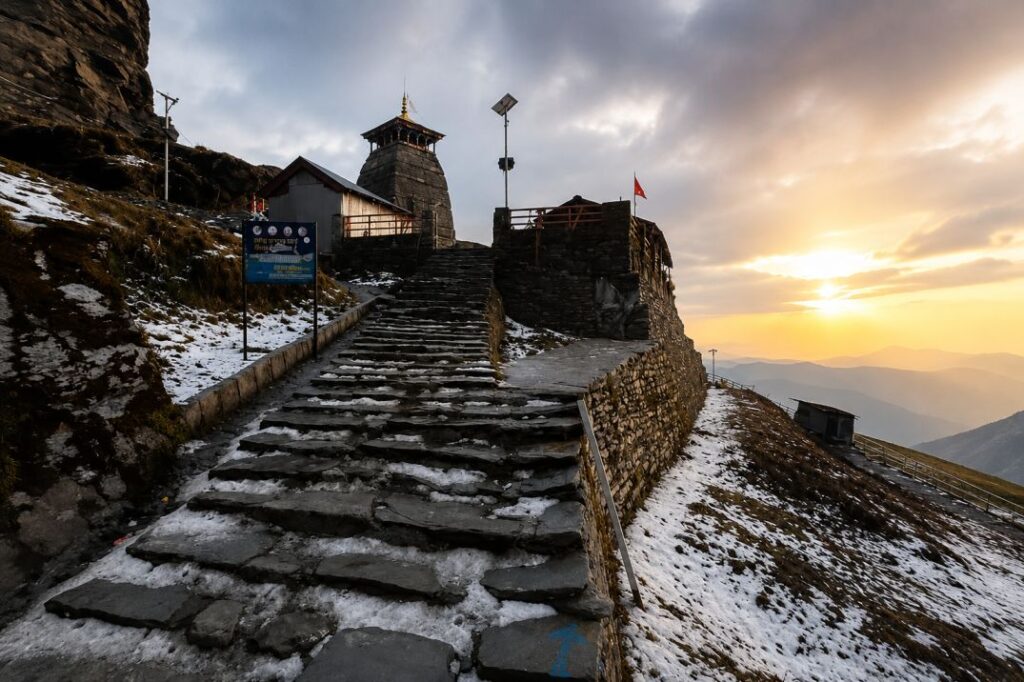 Ancient Tungnath Temple set against mountain peaks on Chopta trek