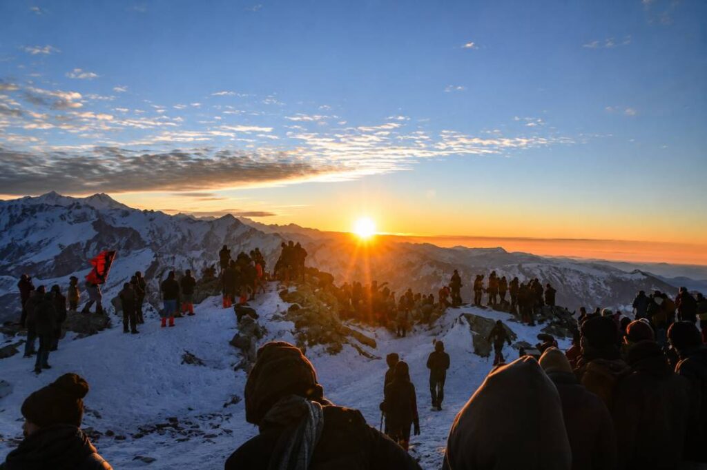 Golden sunset over snow-covered Himalayan peaks seen from Kedarkantha Base Camp in Uttarakhand